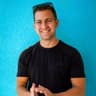 Rob Brautigam, smiling, against a teal wall